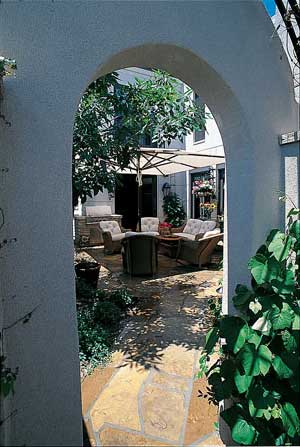 The soothing sounds of water and the scents of summer flowers make this outdoor living space, landscaped by Lifescape Associates, Inc., a room with a natural view.